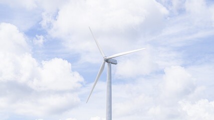 Windmill with sky and clouds background, sustainable natural clean energy concept.