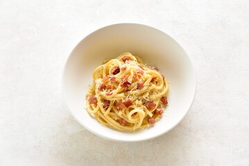 Italian pasta dish with crisp pancetta, parmesan cheese and black pepper