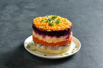 Christmas layered vegetable salad with herring and boiled vegetables