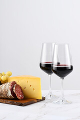 Red wine with charcuterie, cheese and grapes