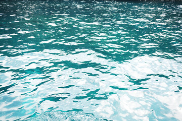 Emerald green waters and turquoise surface of blue sea wave and water background of shore. Travel destination summer of ocean