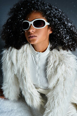 A beautiful woman showcases winter fashion in a chic white ski suit and faux fur jacket, exuding...