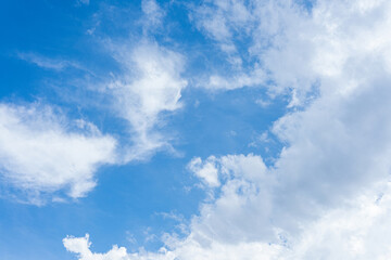 Obraz premium Fluffy white clouds drift across a brilliant blue sky