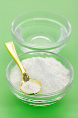Vinegar and baking soda mix in a glass bowl.