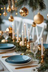 Festively decorated Christmas dinner table with candles, fir branches and Christmas ornaments