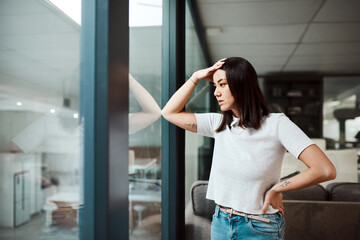 Fototapeta premium Thinking, office and business woman with stress for crisis, failure and mistake by window. Professional, company and person with worry, frustrated and upset for burnout, deadline or unemployment risk