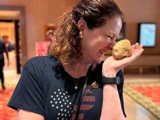 Smiling Star Trek Fan Holding a Tribble Toy