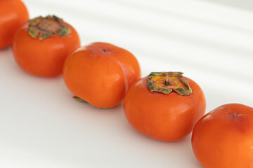 Fresh orange persimmon isolated on white background