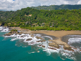 Aerial drone photo of the beautiful beach named Dominicalito at the pacific ocean in Costa Rica. © Robin