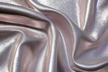 Shiny smooth luxury silver silk fabric. Decorative background for design card, poster, banner for award, reward, Christmas, birthday, wedding. Abstrac curve and wave backdrop template with copy space