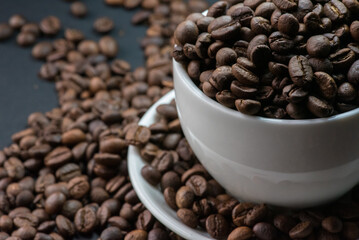 coffee in white cup and coffee beans are the background.