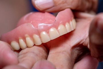 Old denture on a white background.