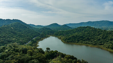 Obraz premium Kaeng Krachan dam with lake view and many green moutain, blue sky background. Kaeng Krachan Dam national park, Phetchaburi province, Thailand in aerial view from drone.