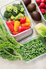 Boxes with fresh raw vegetables on table.