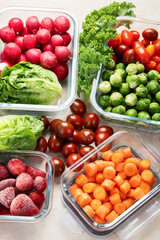Boxes with fresh raw vegetables on table.