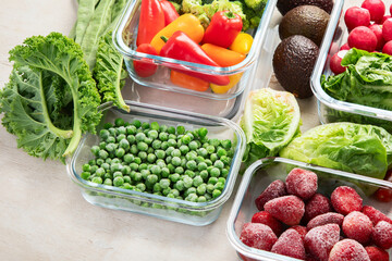 Boxes with fresh raw vegetables on table.