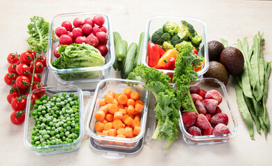 Boxes with fresh raw vegetables on table.