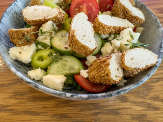 breakfast with sliced turkish bagel simit on fresh salad and cheese