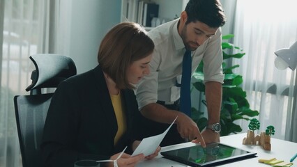 Professional business man presenting sustainable idea to manager by using tablet display ESG...