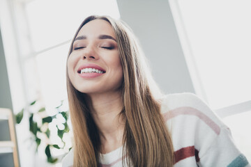 Fototapeta premium Young woman enjoying a peaceful moment in the living room with natural daylight and good mood