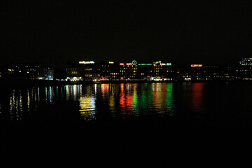 Nightview of Sortedam lake (Sortedams sø) and neon light advertisement billboards in Copenhagen,...