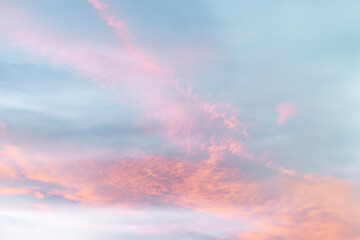 A beautiful sky tinted by the sun leaving vibrant shades of gold, pink, blue and multicolored. Clouds in the twilight evening and morning sky. Cloudy sky background in the evening, and during the day.