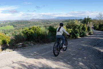 Female on Electric Bike taking a trail ride through Tuscany Italy