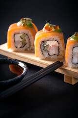 Japanese cuisine. Sushi rolls on a black platter