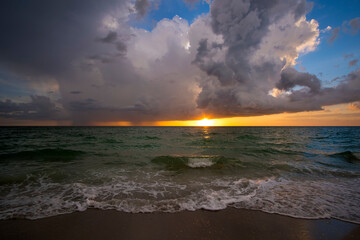 Heavy rain falling down over dark ocean at sunset. Extreme Florida weather in hurricane season