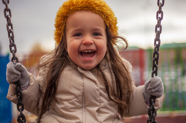 a little girl on the playground and walking
