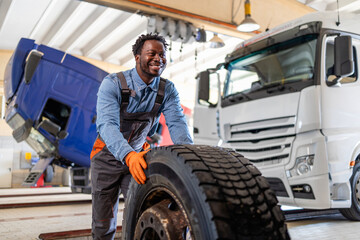 Changing truck tires inside garage workshop.