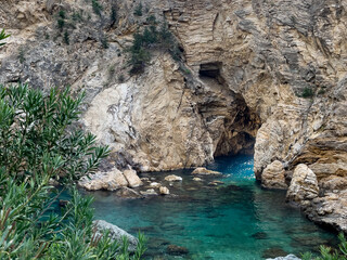 Majestic Rocky Cave with Clear Turquoise Waters and Natural Beauty..
