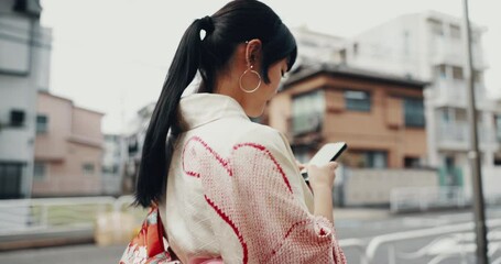 Japanese, girl and walking in kimono with phone for typing text message, online location and search direction. City, person and travel in traditional fashion with smartphone for guide to destination