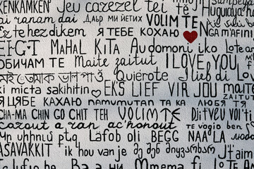 I love you in multiple languages on a textured background.