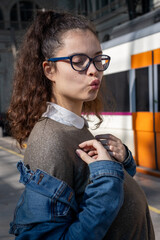 Girl at train station blows a kiss