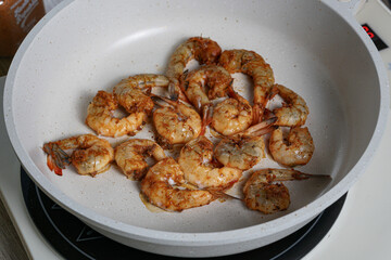 Spicy Shrimp Cooking in a Hot Pan, A Delicious Seafood Dish in the Making