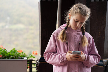 A teen girl engrossed in texting on her phone, capturing the essence of modern communication. Great...