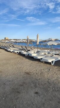 Sun loungers occupying tabarca island beach
