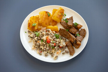 Traditional rustic tropical Brazilian dish, sun-dried beef with green beans, cassava, biquinho pepper. Creative rustic photography