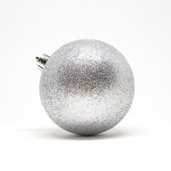 Shiny silver Christmas ornament on a white background