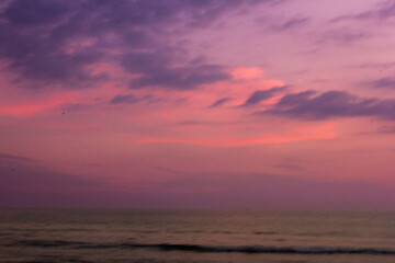 a purple and pink sky with a purple and purple sunset