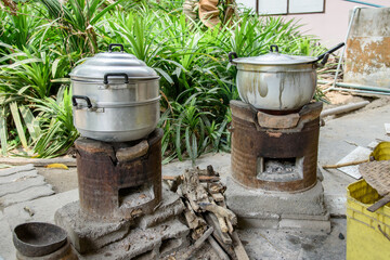 Traditional Thai Cooking Stove with Clay Pot and Firewood in Rural Kitchen