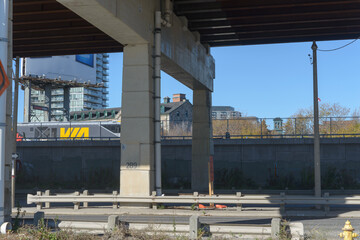 Naklejka premium Via Rail transit heading eastbound in downtown Toronto, Canada (photo taken from Lake Shore Boulevard East almost beneath the Gardiner Expressway in downtown Toronto, Canada