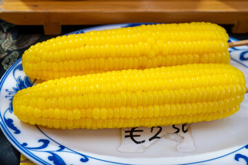 Steamed sweet corn in asian food court on weekly market, vegetarian asian food