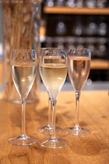 Tasting sparkling white wine, traditional champagne method making of cremant in caves on Moselle river valley in Luxembourg, wine tour and visiting caves