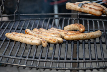 German streetfood, many BBQ wood-fired or charcoal-grilled sausages wurst ready to eat in outdoor cafe, picnic