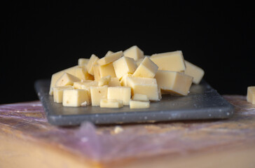 Tasting of different hard cheeses in Italian cheese farm shop