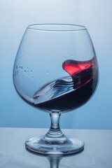 Red wine splashes in the glass 
