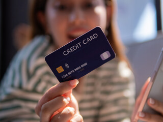 Using a credit card for online shopping home office lifestyle image casual setting close-up shot consumer behavior