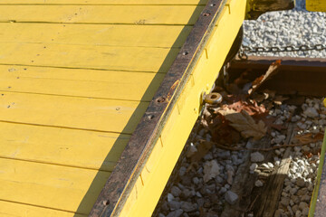 detail of railway flatcar painted yellow outdoors